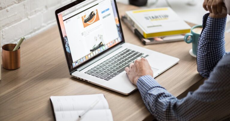 Adult working on a laptop in a modern office setting, illustrating productivity and concentration.