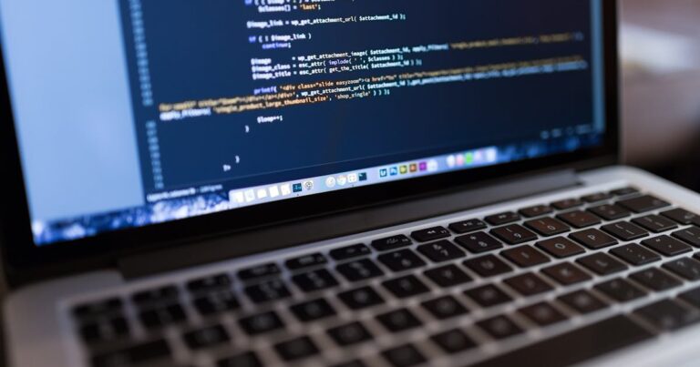 Focused view of programming code displayed on a laptop, ideal for tech and coding themes.