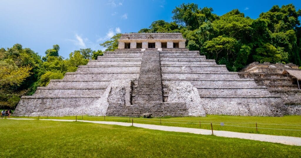 Capture of the iconic Pyramid of the Inscriptions in Palenque, Mexico under clear blue sky.