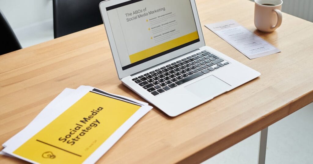 Close-up of a laptop showing a social media marketing strategy in an office setting.