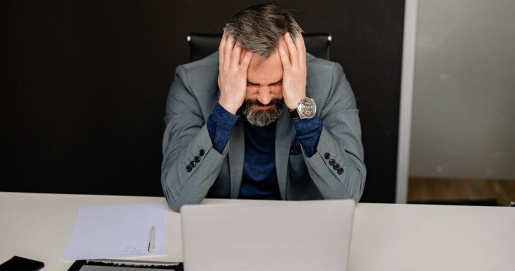 small business owner screening resumes by hand at a desk